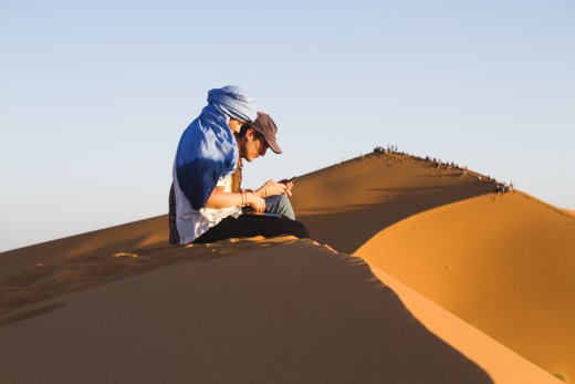 two people sitting on dune